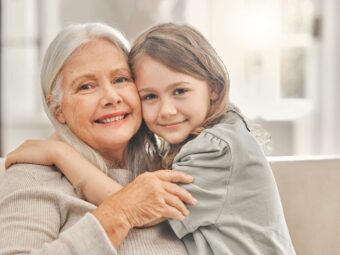 grandma-girl-portrait-sofa-hug-love-relationship-development-home-senior-woman-grandchild-bonding-couch-family-values-womens-day-weekend-relax-living-room