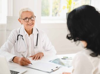 Gynecologist prescribing medicines, health insurance with female patient during hospital appointment