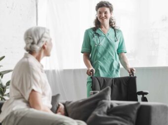 senior-woman-looking-smiling-female-nurse-with-wheelchair